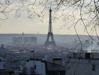 View of tower and buildings against sky