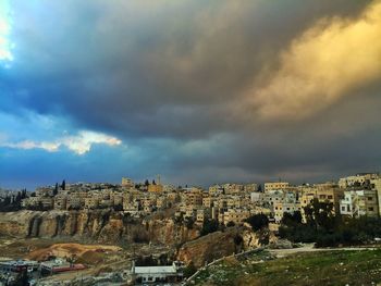 Buildings against cloudy sky