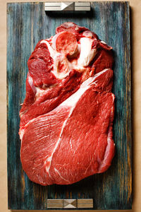 Top view of beef raw meat on wooden tray