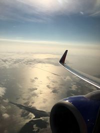 Cropped image of airplane wing over landscape