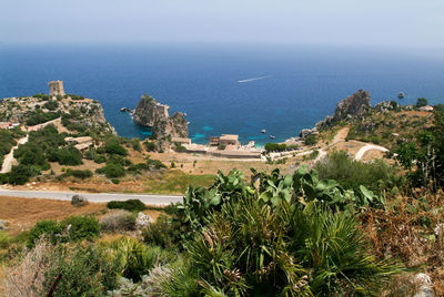 High angle view of townscape by sea against sky