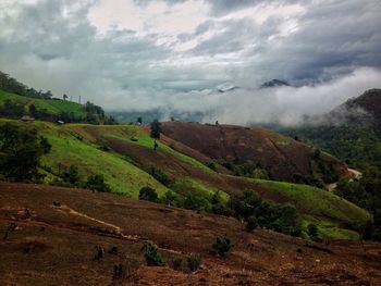 Scenic view of landscape against dramatic sky