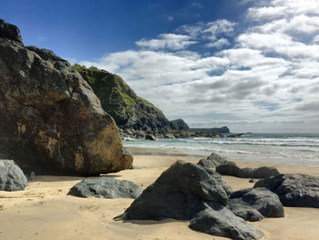 Rocks on beach against sky