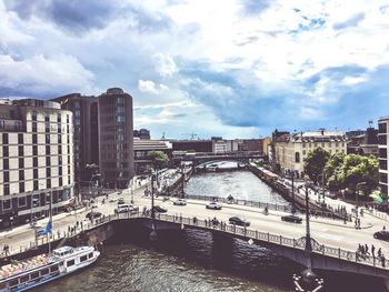 River in city against cloudy sky