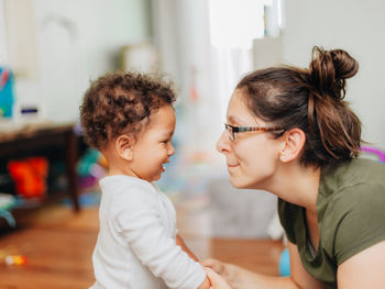 Side view of mother and son at home