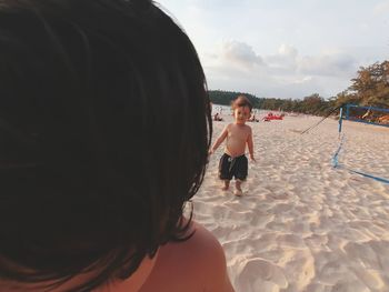 Portrait of shirtless girl on beach