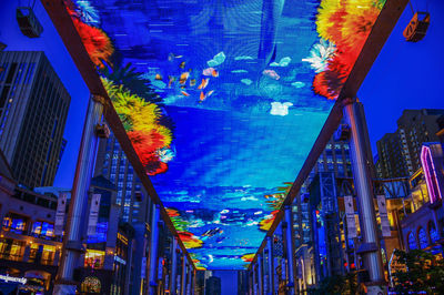 Low angle view of illuminated buildings in city at night