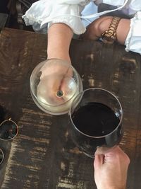 Low section of woman pouring coffee cup