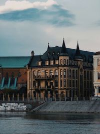 Building next to river against sky