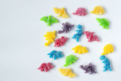 Dinosaurs jelly bonn, candies on the white background, colorful jelly