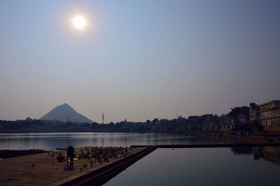 Scenic view of lake against clear sky during sunset