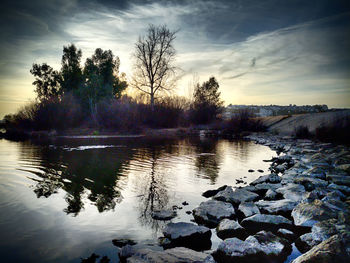 Scenic view of lake against sky at sunset