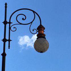 Low angle view of street light against blue sky