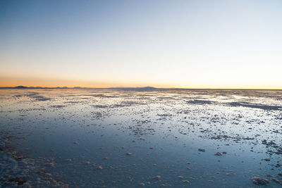 Scenic view of sea against clear sky during sunset