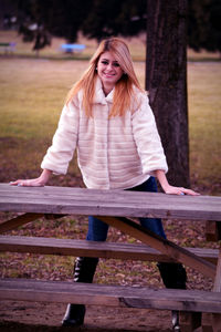 Portrait of young woman sitting outdoors