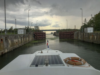 View of ship in river against sky