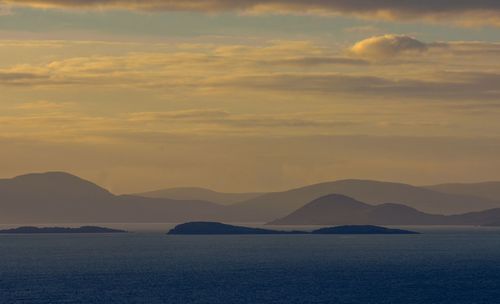 Scenic view of sea against romantic sky at sunset