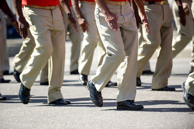 Low section of people walking on street