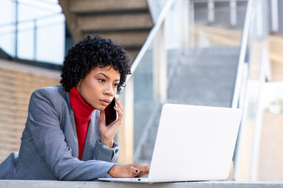 Young elegant african american woman in an office building attending a video conference 