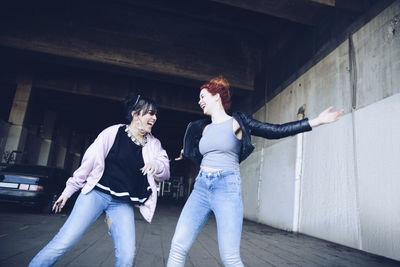 Hipster female friends enjoying at parking lot