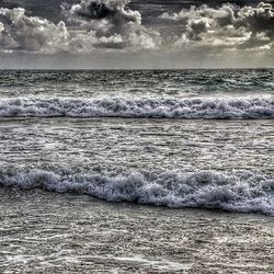 Scenic view of sea against cloudy sky