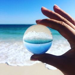 Close-up of woman holding glass of water