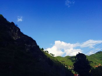 Scenic view of mountains against blue sky