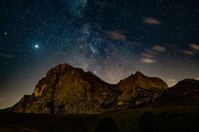 Scenic view of mountains against sky at night