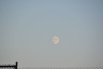 Low angle view of moon against clear sky at night