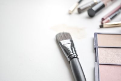 High angle view of tools on table against white background