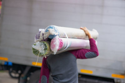 A man is shouldering the carpet