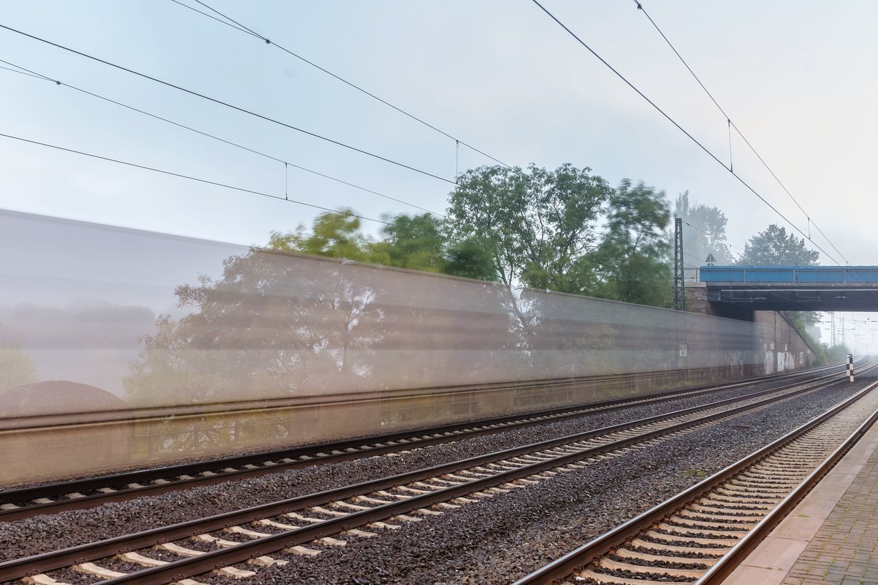 RAILWAY TRACKS AGAINST SKY SEEN THROUGH TRAIN WINDSHIELD