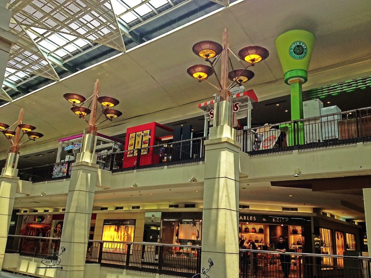 indoors, architecture, built structure, ceiling, public transportation, illuminated, low angle view, railroad station, rail transportation, interior, lighting equipment, architectural column, building, building exterior, train - vehicle, railroad station platform, window, subway station, no people, transportation