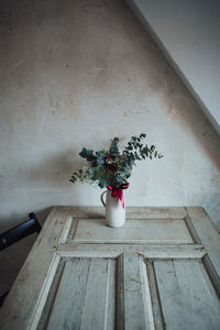 High angle view of vase with bunch of flowers on table