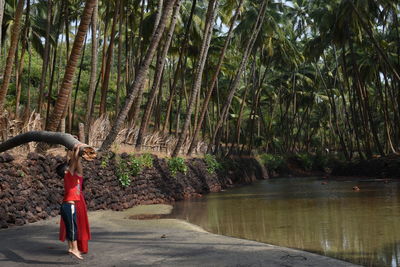 Woman standing by plants