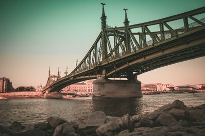 View of bridge over river in city