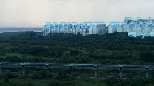 Bridge over trees against sky