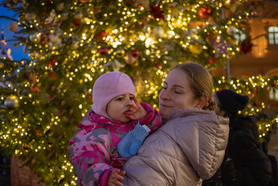 Rear view of mother and daughter on tree