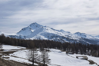 Scenic view of snow covered mountains against sky