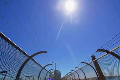 Low angle view of cables against blue sky