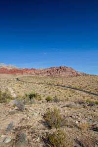 Scenic view of arid landscape against clear blue sky. red rock canyon, nevada 