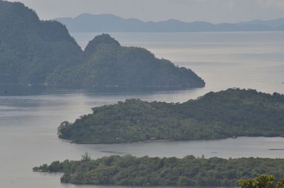 Scenic view of river and mountains against sky