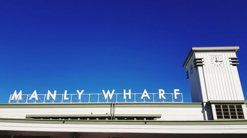 Low angle view of building against clear blue sky