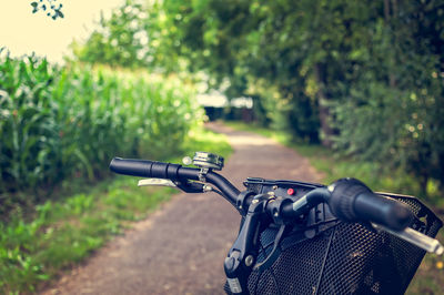 Bicycle on field against trees