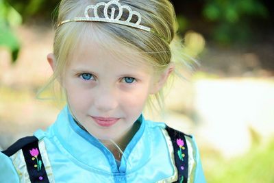 Close-up portrait of girl wearing crown