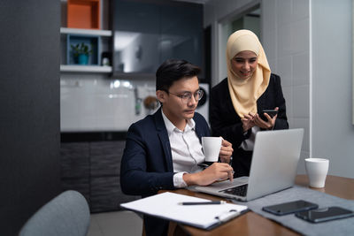 Business people working at desk in office cafeteria