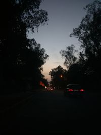 Cars on road at sunset