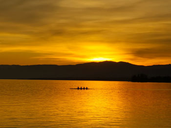 Scenic view of lake against orange sky