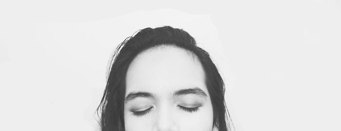 Close-up portrait of young woman over white background