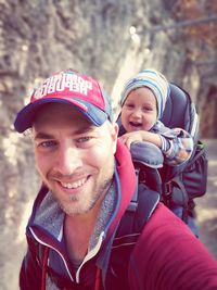 Portrait of smiling young man in park during winter